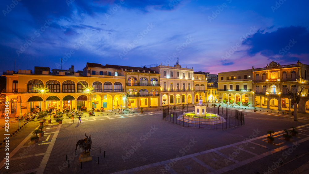 The Old Square, Plaza Vieja in Spanish, at twilight, Old Havana, Cuba.