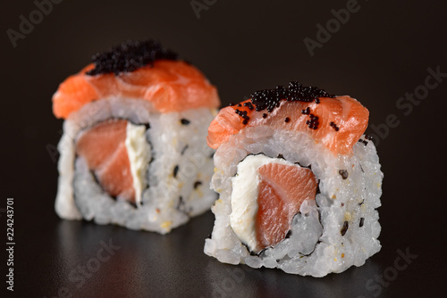 Salmon sushi couple on dark background