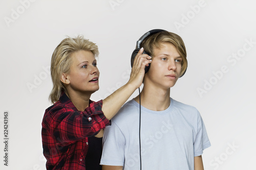 Mom and a teenage son are arguing with each other against white background
