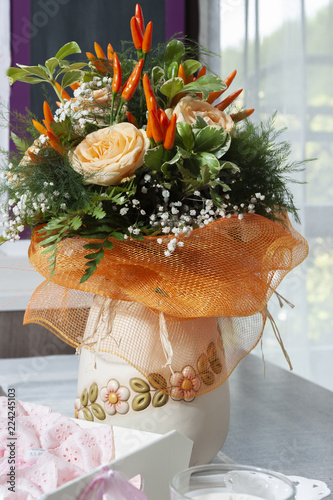 Roses and peppers into a vase