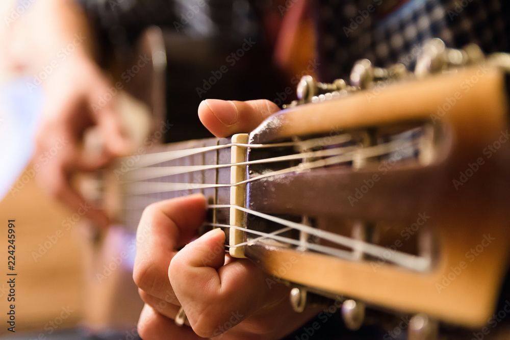 Obraz premium Young guy playing the classical guitar
