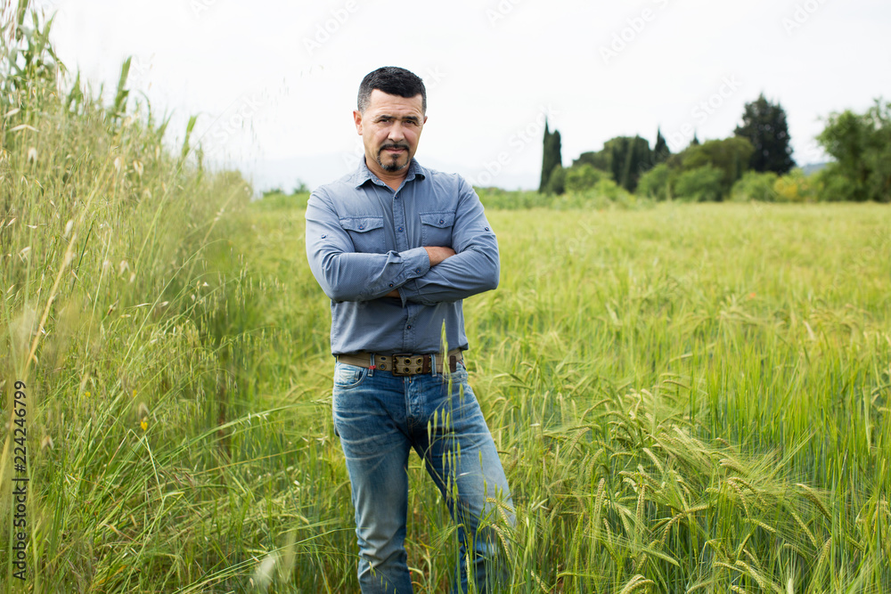 Man standing in green field