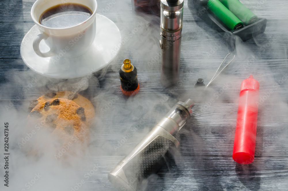 Still life with e-ciggarete and coffe on the wooden background