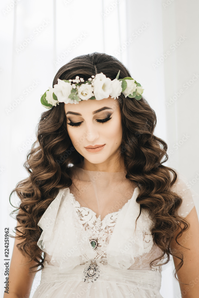 Gorgeous Beautiful Bride portrait with wedding and long curly wears cristal wreath and bridal dress. Stock-foto Adobe Stock