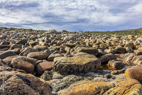 Picturesque view of the rocky shoreline of Atlantic Ocean and Platboom Beach. Platboom Bay is a beautiful beach along coastline nestled in Cape of Good Hope Nature reserve, Cape Town, South Africa.