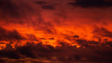 A dramatic and reddish view in a sunset sky with a lot of clouds transmitting a threaten feeling