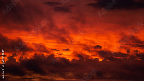 A dramatic and reddish view in a sunset sky with a lot of clouds transmitting a threaten feeling