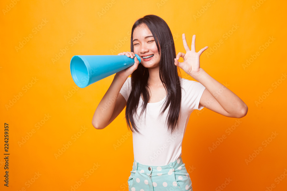 Beautiful young Asian woman show OK announce with megaphone. Beautiful young Asian woman show OK announce with megaphone.