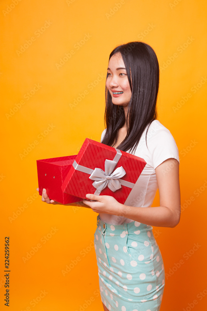 Young Asian woman open a gift box. Young Asian woman open a gift box.