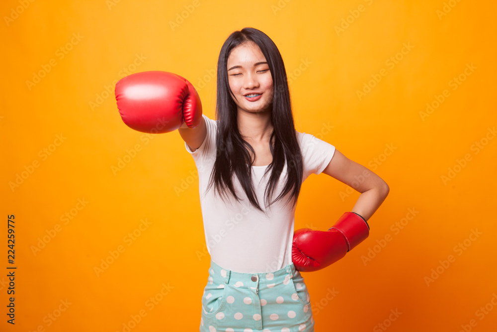 Young Asian woman with red boxing gloves. Young Asian woman with red boxing gloves.