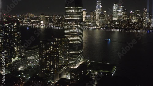 Epic aerial shot of Jersey City and New York City skyline at night.