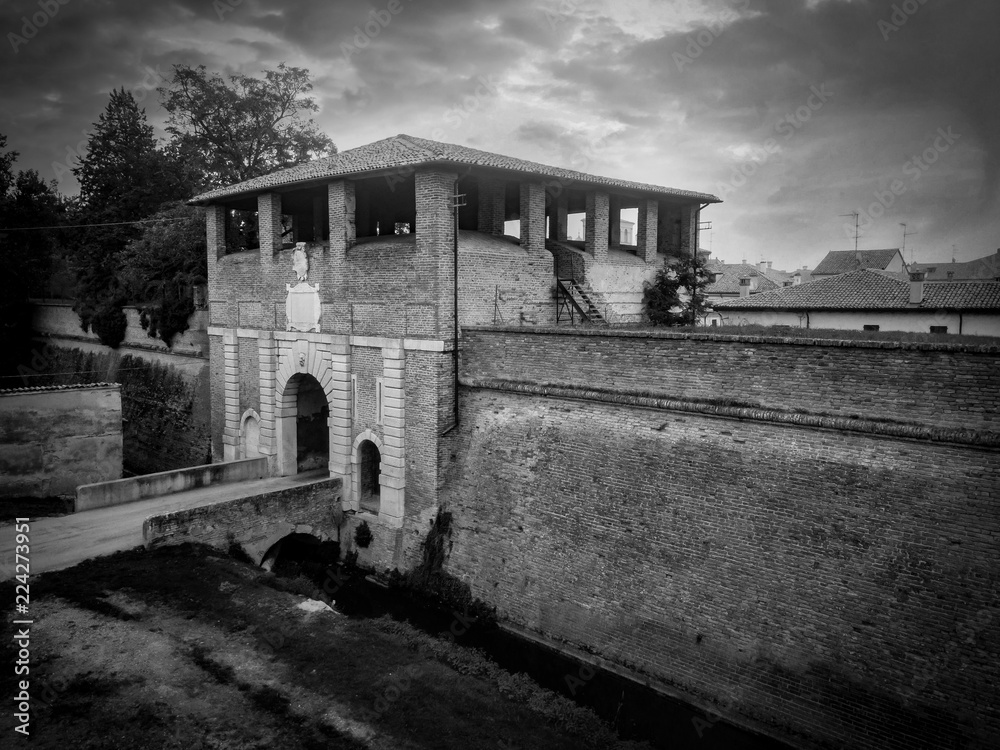 Black and white aerial view of the gate tower and walls of the perfect planned start shaped renaissance city Sabbioneta in Italy 