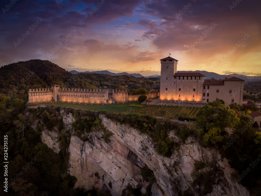 Medieval castle in Angera Italy with dramatic purple, red, yellow sky