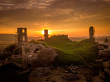 Aerial sunset panorama with orange sunset sky of medieval ruined Plavec castle in Slovakia over the Poprad river