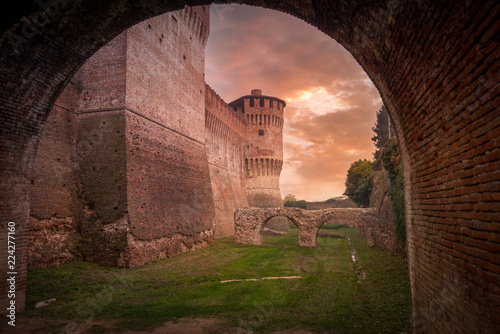 Aerial view of unique medieval Soncino castle near Cremona Lombardy with Gothic and renaissance towers, walls, battlements against a colorful sunset background  photo