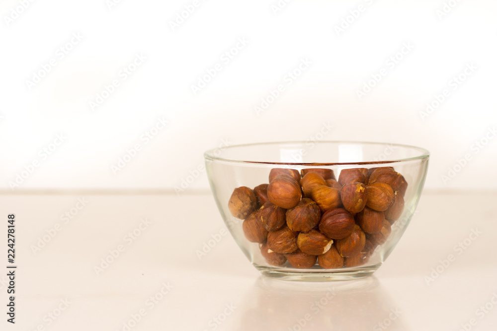 hazelnut kernels in transparent glass bowl hazelnut kernels in transparent glass bowl