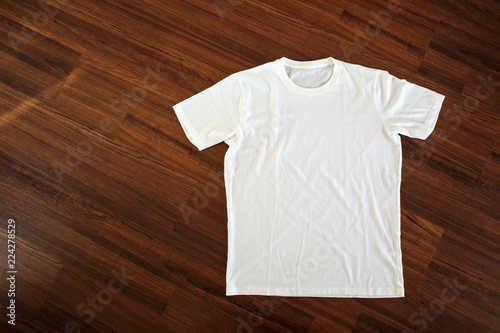 White t-shirt on wood background
