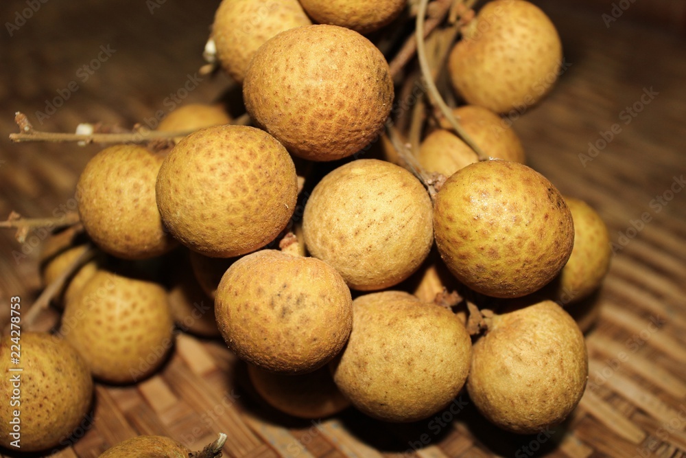 Longan fruits or Dimocarpus longan or Dragon eye fruit on the wooden wicker. Longan fruits or Dimocarpus longan or Dragon eye fruit on the wooden wicker.