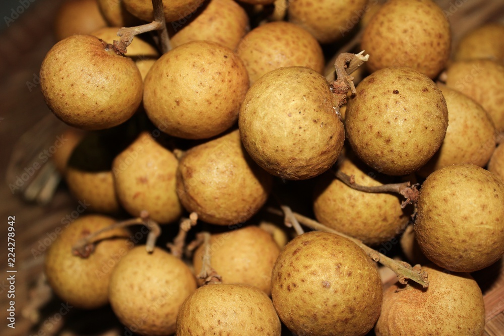 Longan fruits or Dimocarpus longan or Dragon eye fruit on the wooden wicker. Longan fruits or Dimocarpus longan or Dragon eye fruit on the wooden wicker.