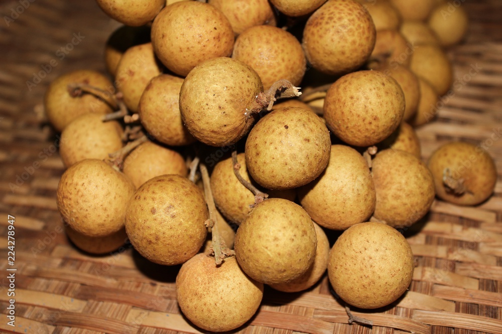 Longan fruits or Dimocarpus longan or Dragon eye fruit on the wooden wicker. Longan fruits or Dimocarpus longan or Dragon eye fruit on the wooden wicker.