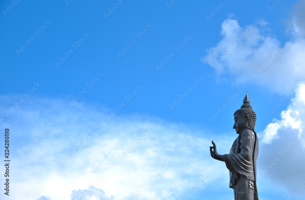Fototapeta premium buddha statue on sunshine blue sky
