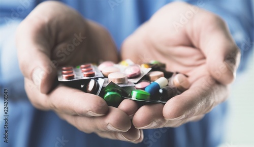 Pills in human hands, close-up view