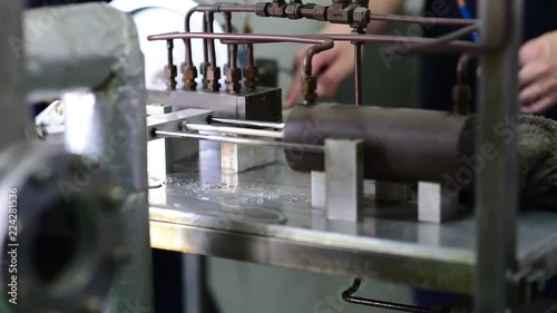 Electric water pumping machine running. Inside a workshop. Slowmotion. photo