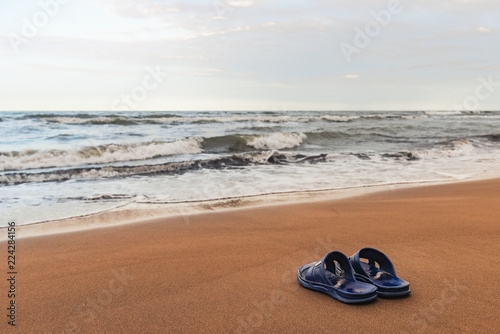 Slippers on the sand near the sea