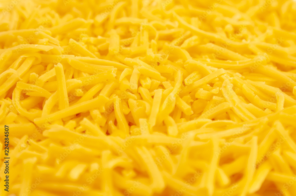 Background of Grated Orange Cheddar Cheese Background of Grated Orange Cheddar Cheese