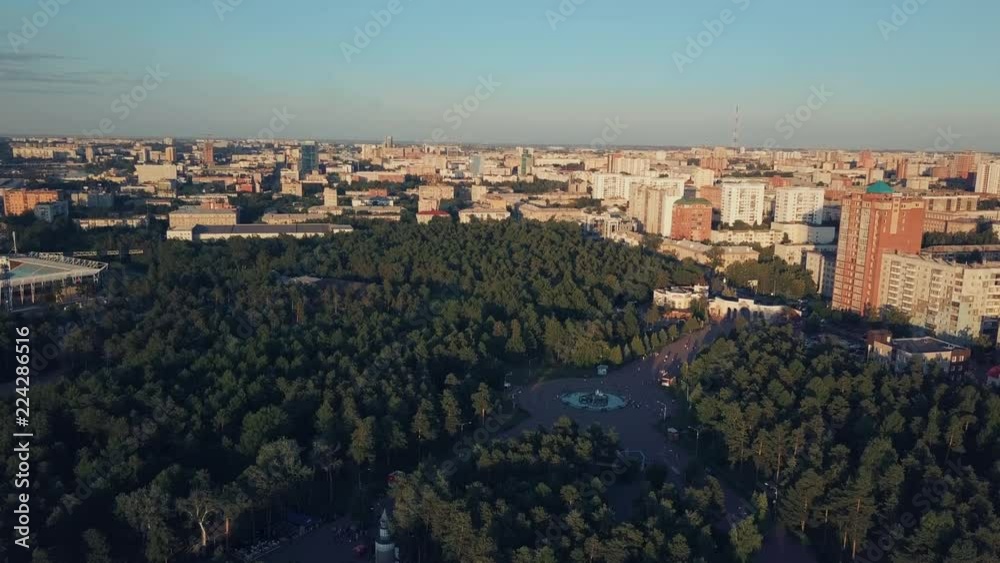 Aerial drone flight over the huge park with mixed forest in the center of Chelyabinsk city, sunny evening in the capital of South Ural, Russia Aerial drone flight over the huge park with mixed forest in the center of Chelyabinsk city, sunny evening in the capital of South Ural, Russia