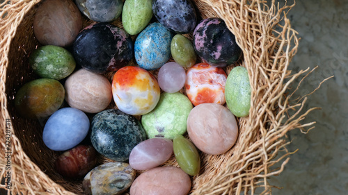 A nest of colorful semi-precious gemstone pebbles