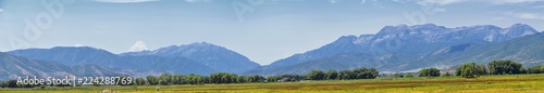 Panoramic Landscape view from Heber, Utah County, view of backside of Mount Timpanogos near Deer Creek Reservoir in the Wasatch Front Rocky Mountains, and Cloudscape. Utah, USA.