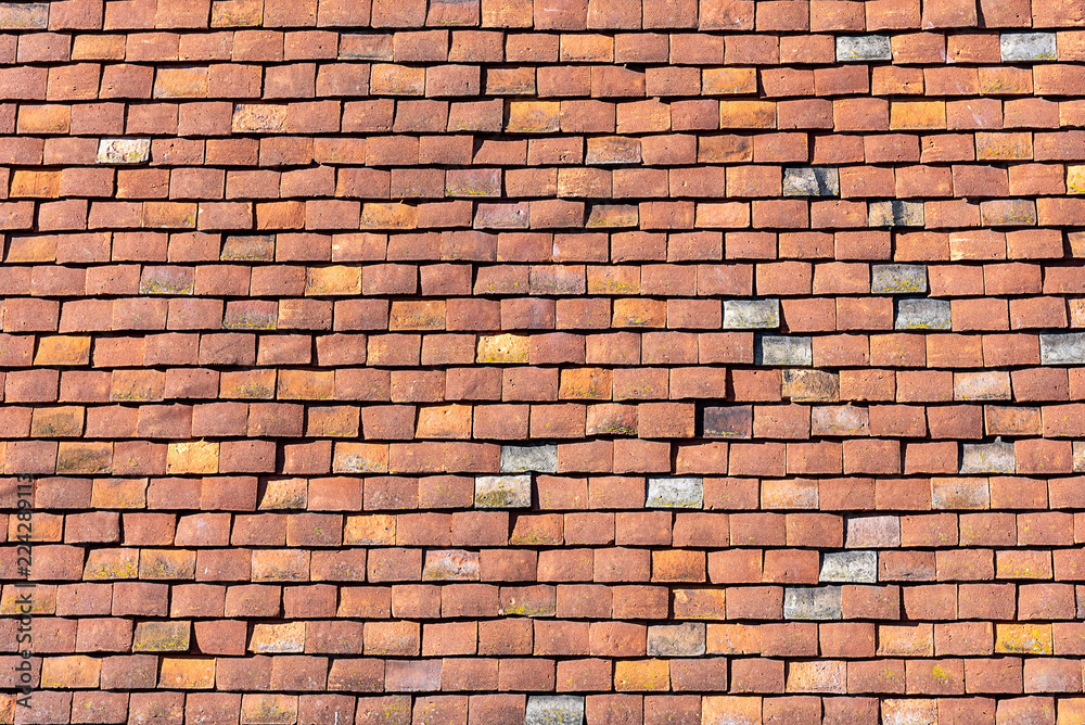 Naklejka premium Background from a house wall made of red old shingles
