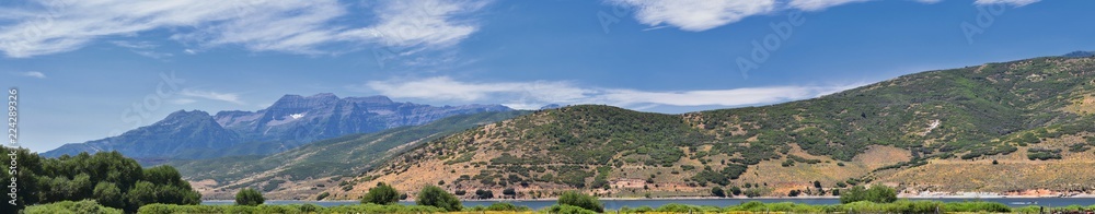 Panoramic Landscape view from Heber, Utah County, view of backside of Mount Timpanogos near Deer Creek Reservoir in the Wasatch Front Rocky Mountains, and Cloudscape. Utah, USA.