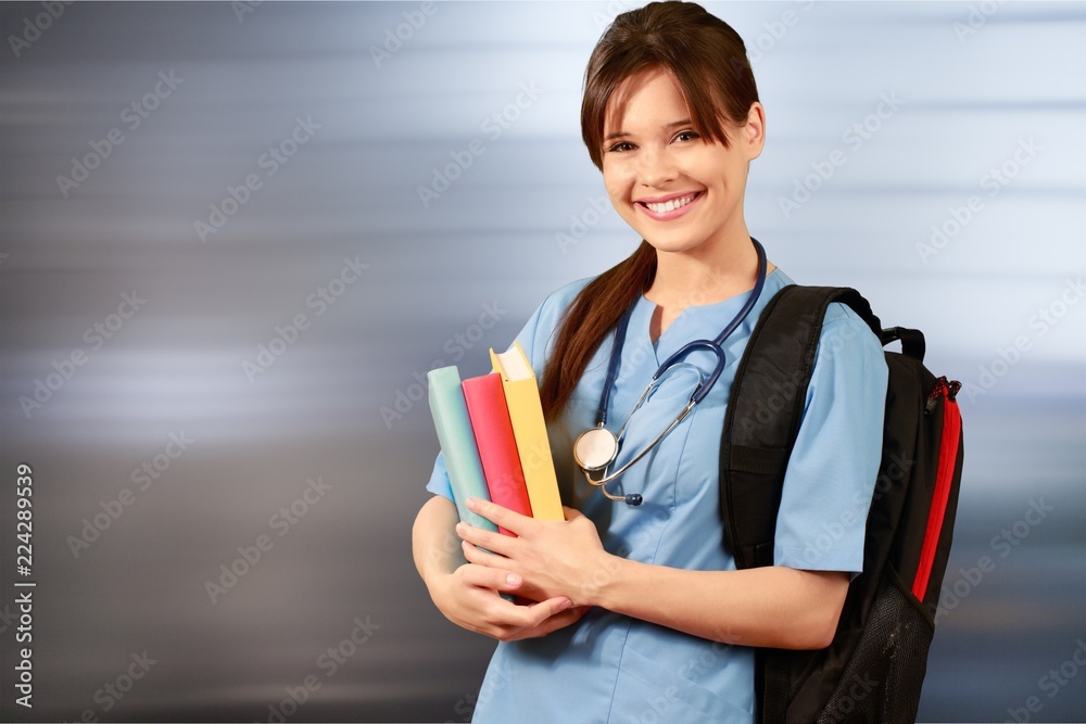 Attractive young female doctor student on background Attractive young female doctor student on background