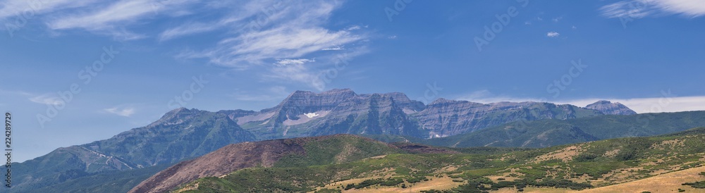 Panoramic Landscape view from Heber, Utah County, view of backside of Mount Timpanogos near Deer Creek Reservoir in the Wasatch Front Rocky Mountains, and Cloudscape. Utah, USA.
