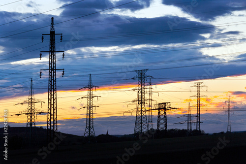 Electricity - Power energy Industry - Electric poles at the sunset with coloful sky photo