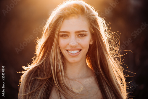 Sensual woman portrait. Sunny day. Smile of a beautiful stranger. Hair care. Sunburn on the face. Sunny morning for a merry day. Close up portrait