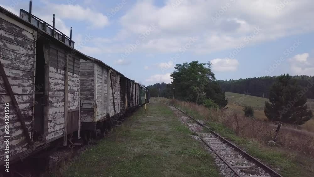 Stunning 4k aerial of steam engine train carriages and locomotive with puffs Stunning 4k aerial of steam engine train carriages and locomotive with puffs
