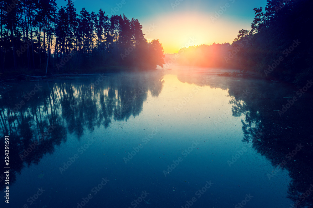 Early in the morning, sunrise over the lake. Wild nature