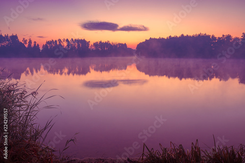 Fototapeta Naklejka Na Ścianę i Meble -  Early in the morning. Magic purple sunrise over the lake