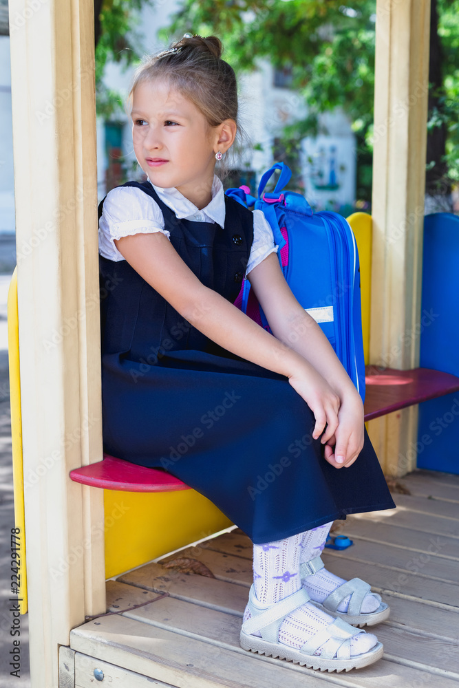 Fototapeta premium An elementary school student is sitting on the playground.