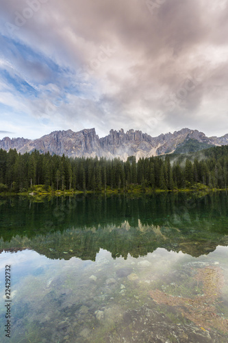 Fototapeta Naklejka Na Ścianę i Meble -  Dramatic sunset with rain clouds and rocky peaks in the Dolomite Alps, Italy, in summer