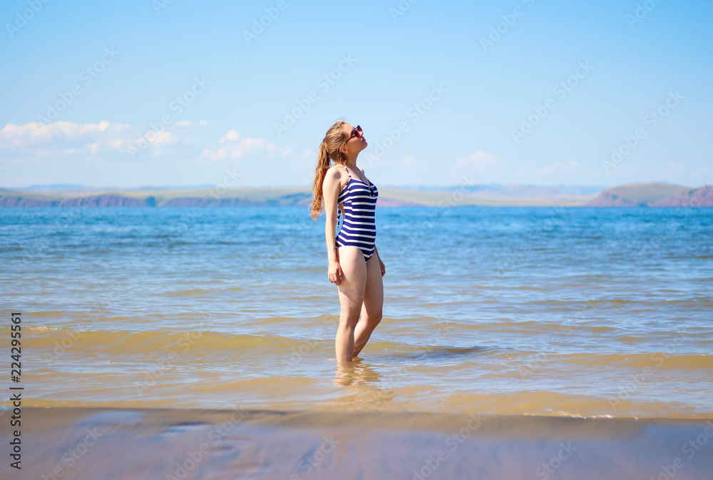 Beautiful girl with glasses and swimsuit on the sea Beautiful girl with glasses and swimsuit on the sea