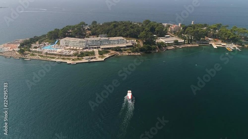 Boat arriving to Sv. Nikola island near Porec, Istria, Croatia photo