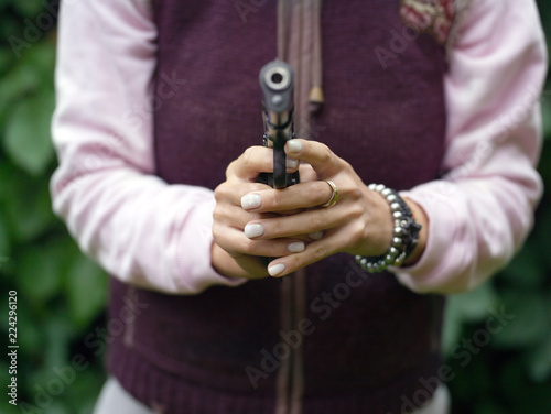 Female hands with gun