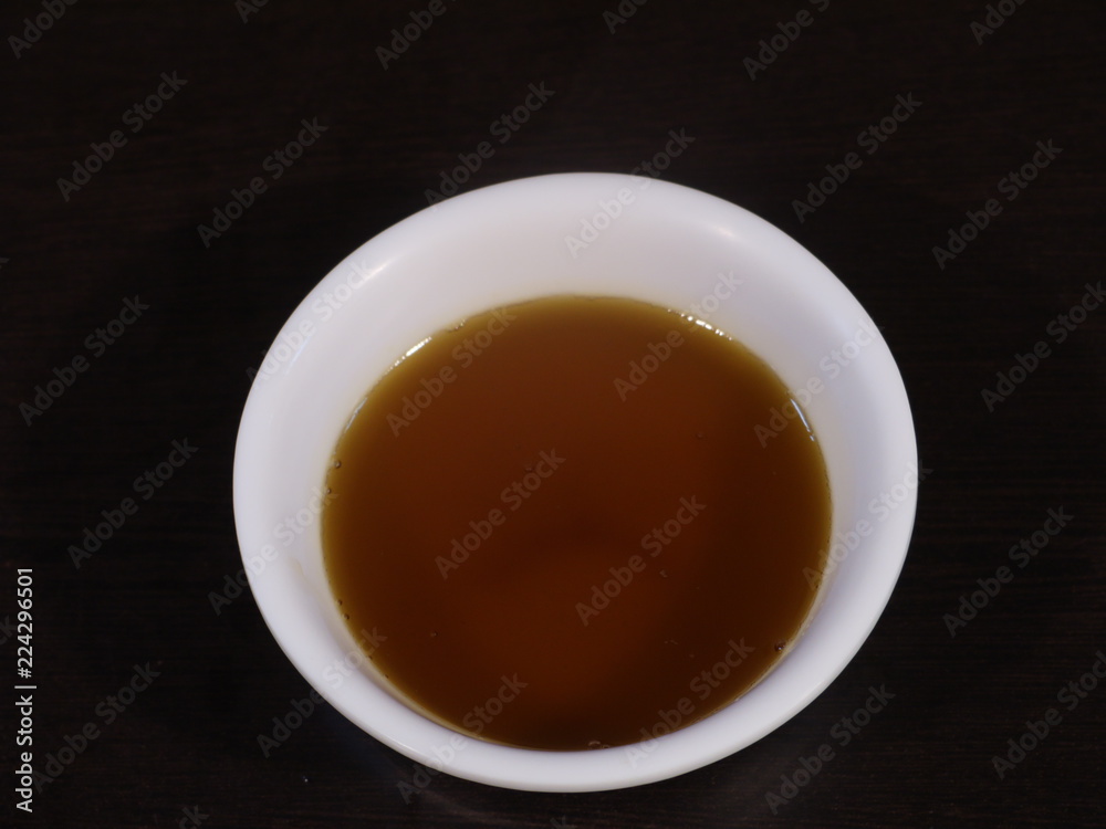 Mustard Oil in White Bowl on Wooden Background,Mustard Oil in White Bowl on Hand, Closeup of Mustard oil in Hand, Mustard Oil in White Bowl on Wooden Background,Mustard Oil in White Bowl on Hand, Closeup of Mustard oil in Hand,