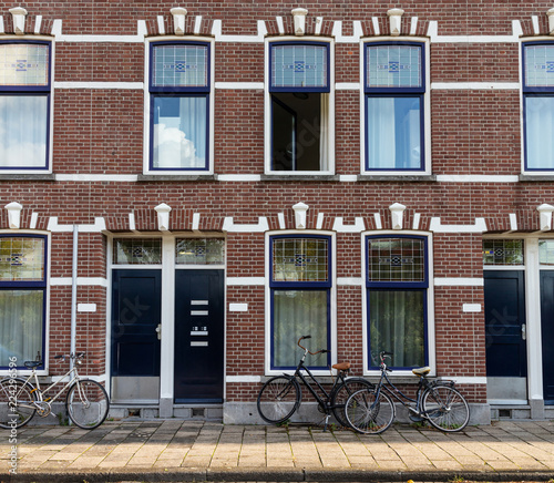 Bikes in front of red brick house in Rotterdam, background