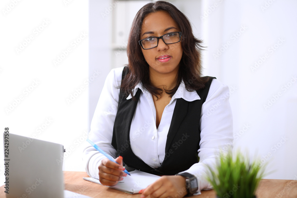 African American business woman is busy with paper job in office