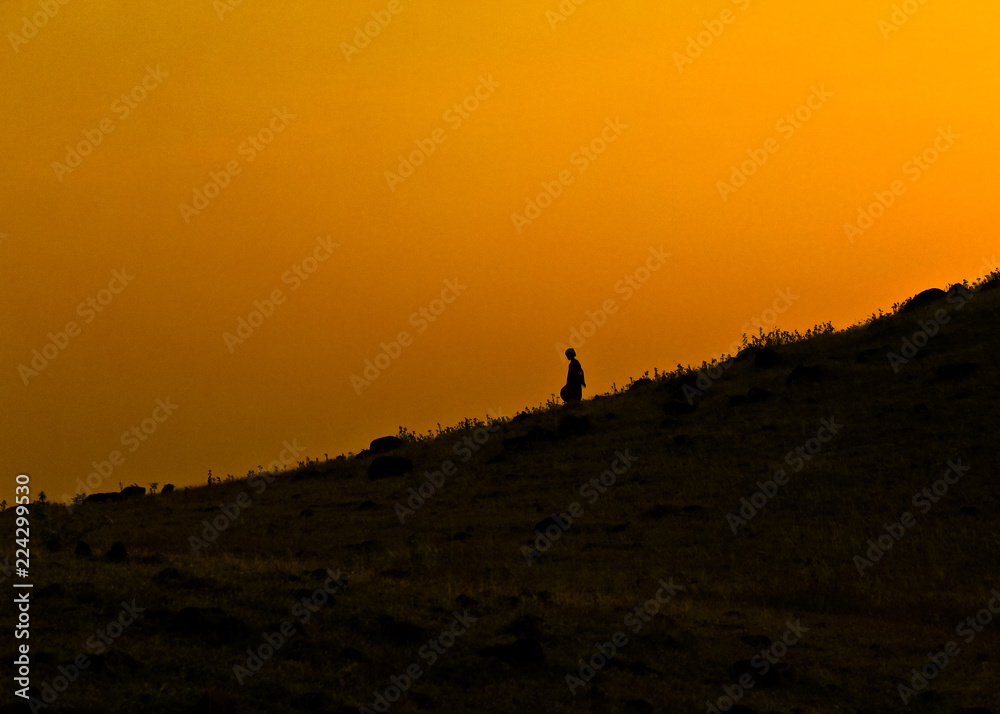 silhouette of a man on top of the mountain